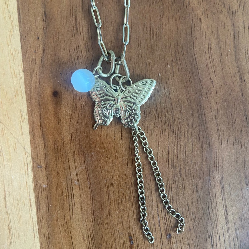 Gold tone chain necklace with cute charms, butterfly, bead and chain dangles